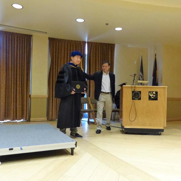 Advisor congratulating Grad