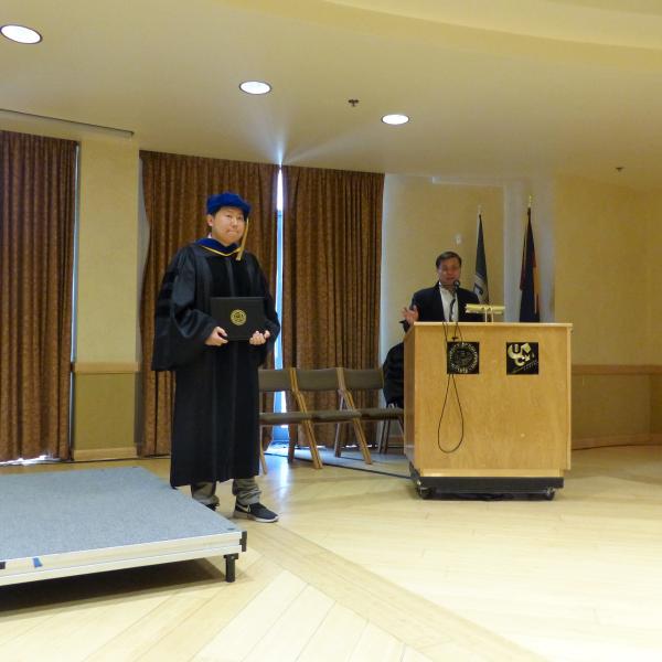 Advisor congratulating Grad