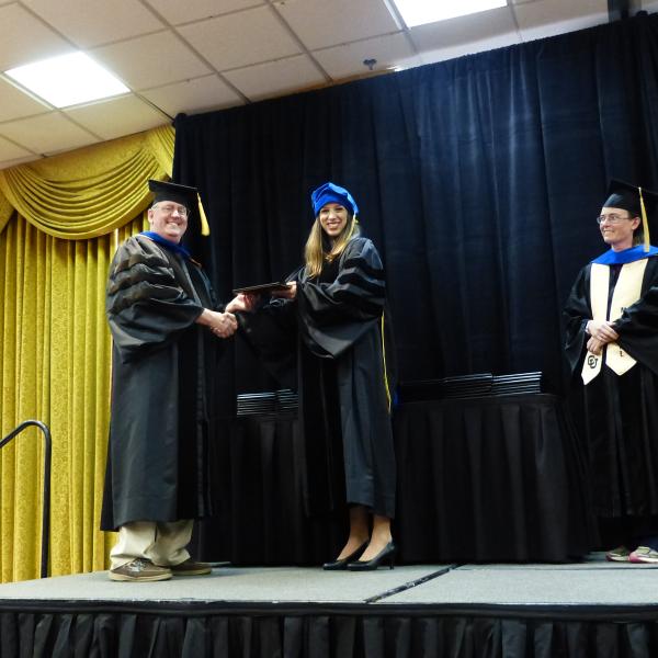 Chair, Carl Koval congratulating Ph.D. graduate Marissa McKercher