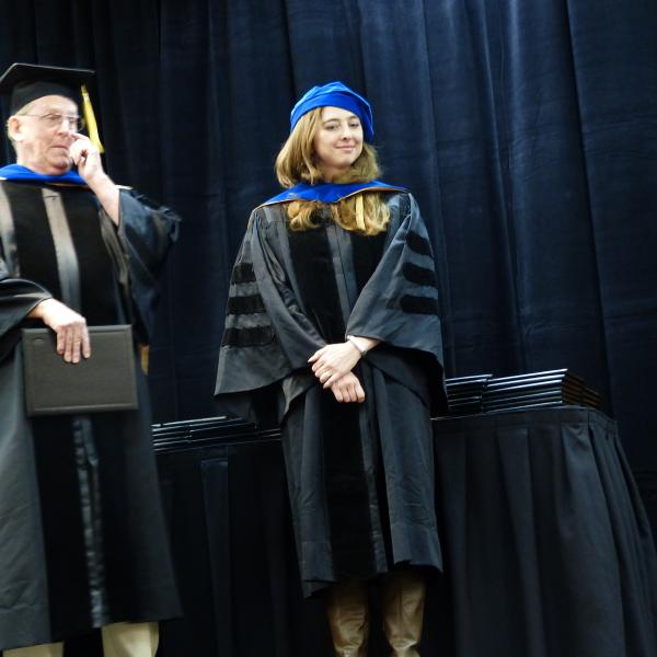Chair, Carl Koval congratulating Ph.D. graduate Christina Smith