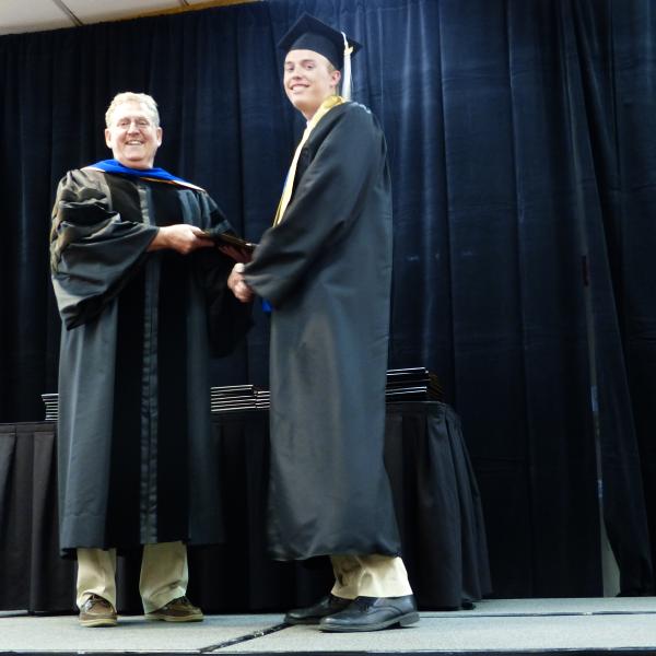 Chair, Carl Koval, congratulating undergraduate student_3