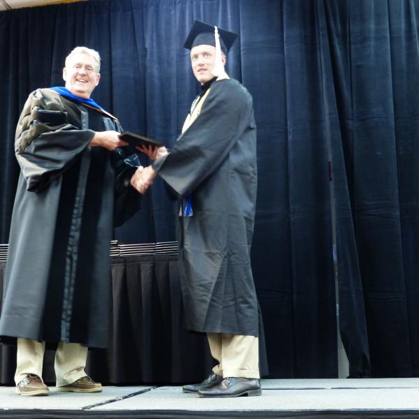 Chair, Carl Koval, congratulating undergraduate student_4