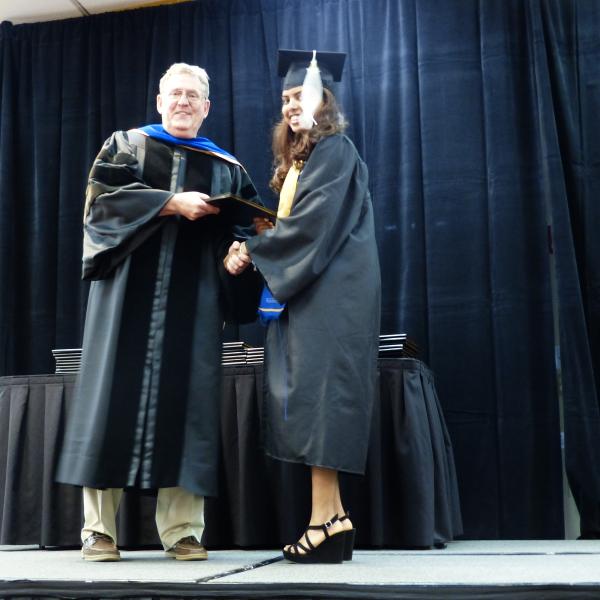Chair, Carl Koval, congratulating undergraduate student_5