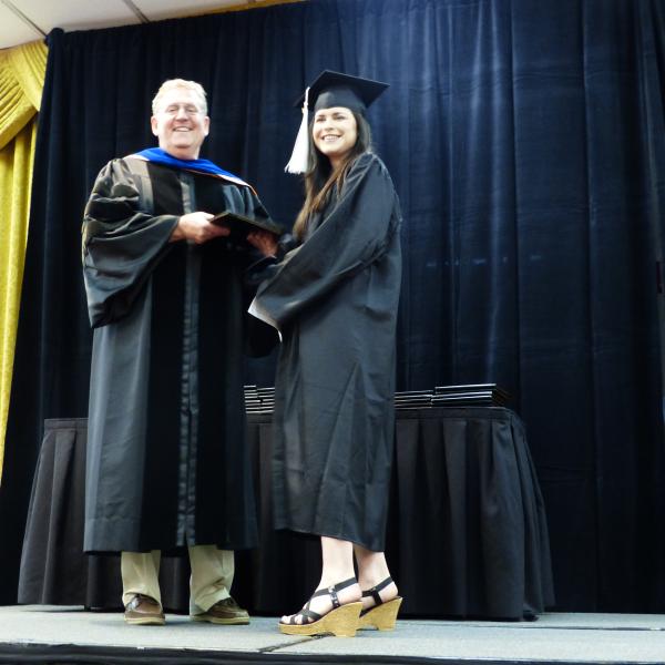 Chair, Carl Koval, congratulating undergraduate student_7