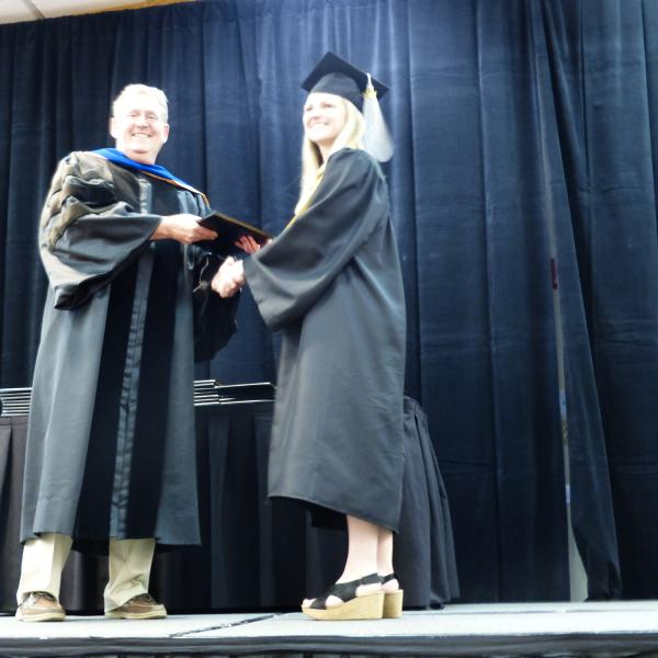 Chair, Carl Koval, congratulating undergraduate student_9