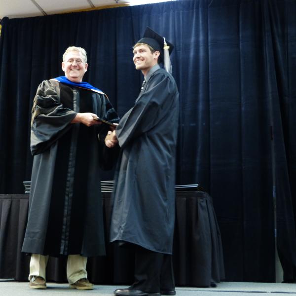 Chair, Carl Koval, congratulating undergraduate student_10