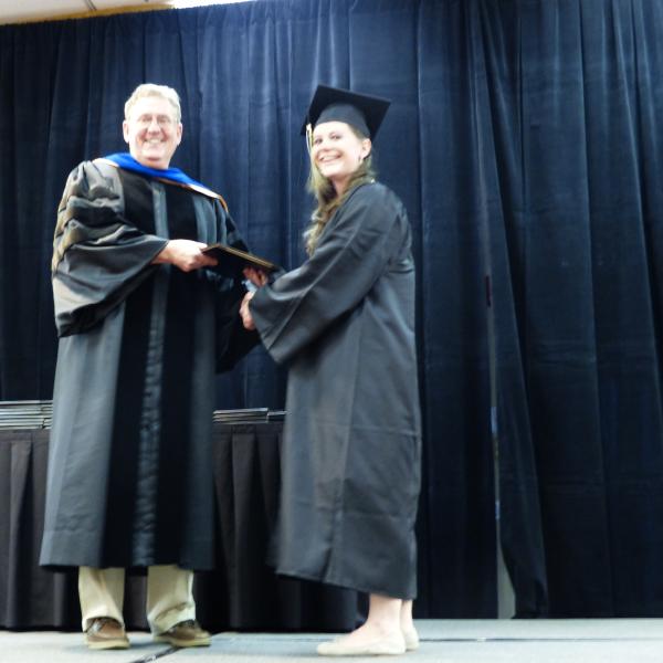 Chair, Carl Koval, congratulating undergraduate student_11