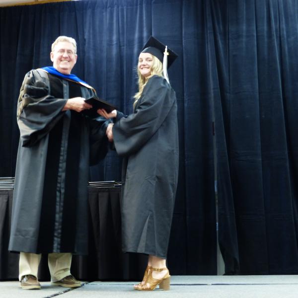 Chair, Carl Koval, congratulating undergraduate student_12