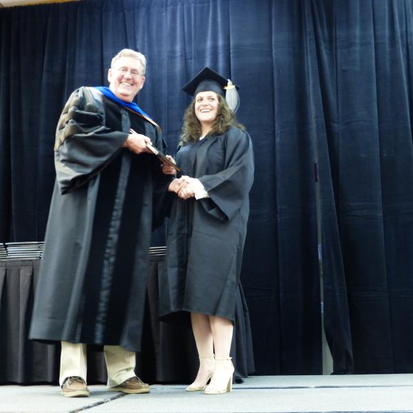 Chair, Carl Koval, congratulating undergraduate student_13
