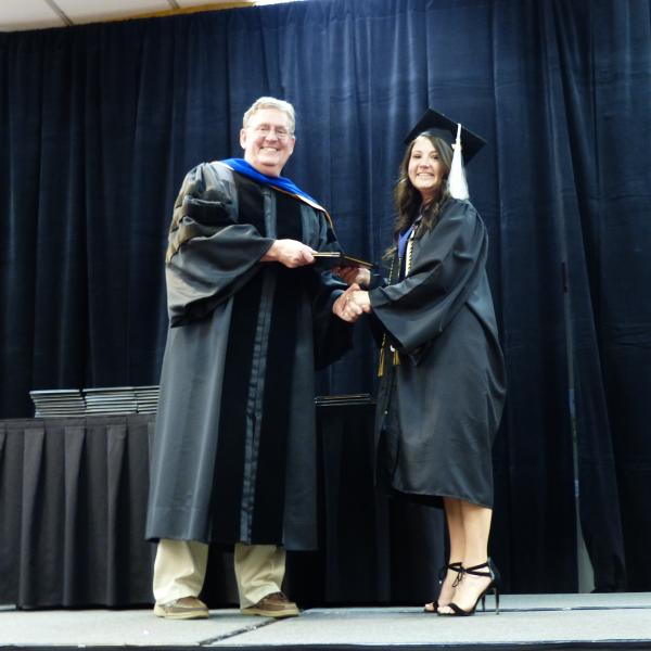 Chair, Carl Koval, congratulating undergraduate student_18