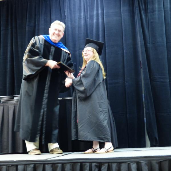 Chair, Carl Koval, congratulating undergraduate student_21