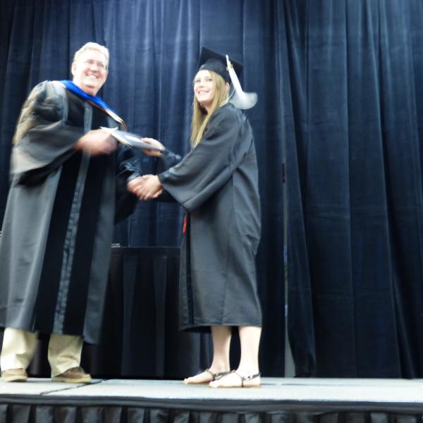 Chair, Carl Koval, congratulating undergraduate student_22