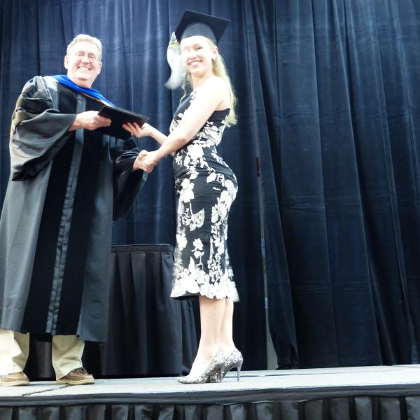 Chair, Carl Koval, congratulating undergraduate student_23