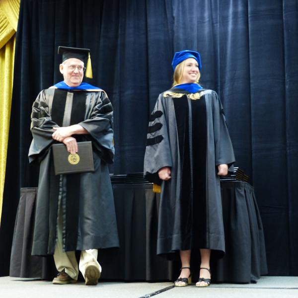 Chair, Carl Koval and Ph.D. graduate Alexandra Young