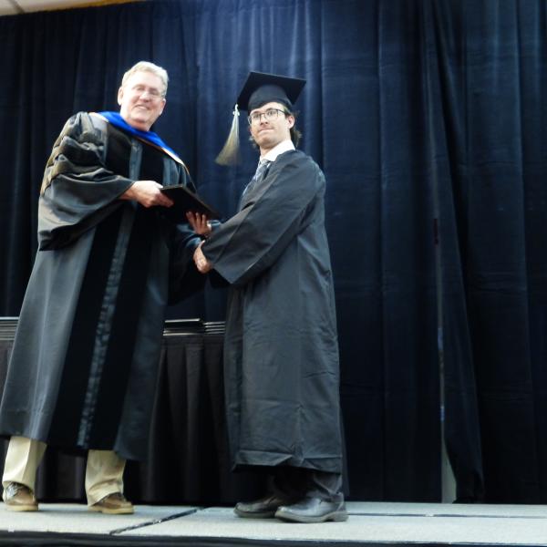 Chair, Carl Koval, congratulating undergraduate student_8