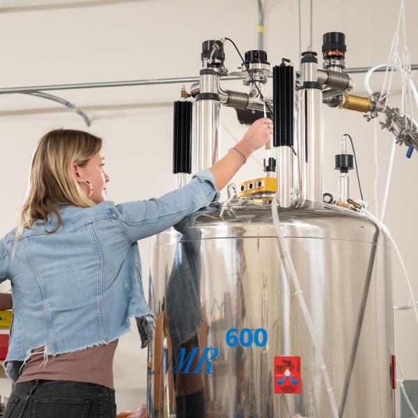 A researcher putting a sample into an NMR