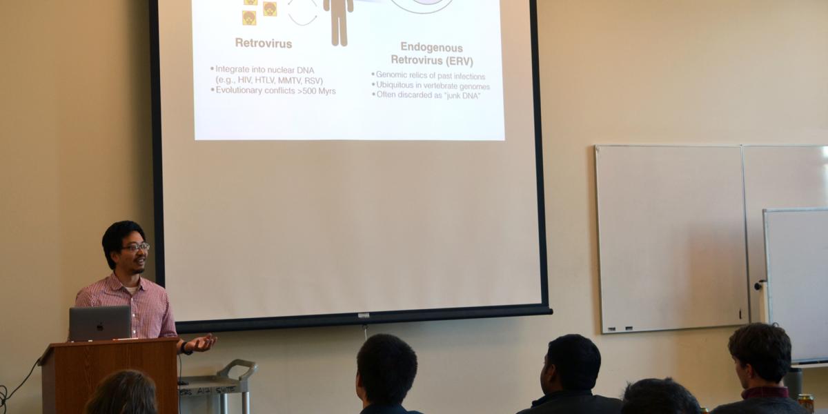 An audience watching a presentation about viruses