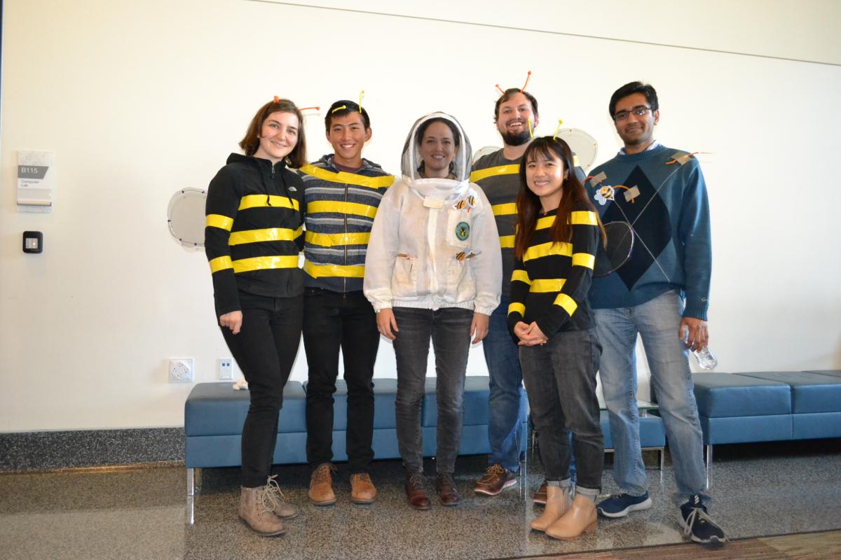 A group of people dressed as bees and a beekeeper