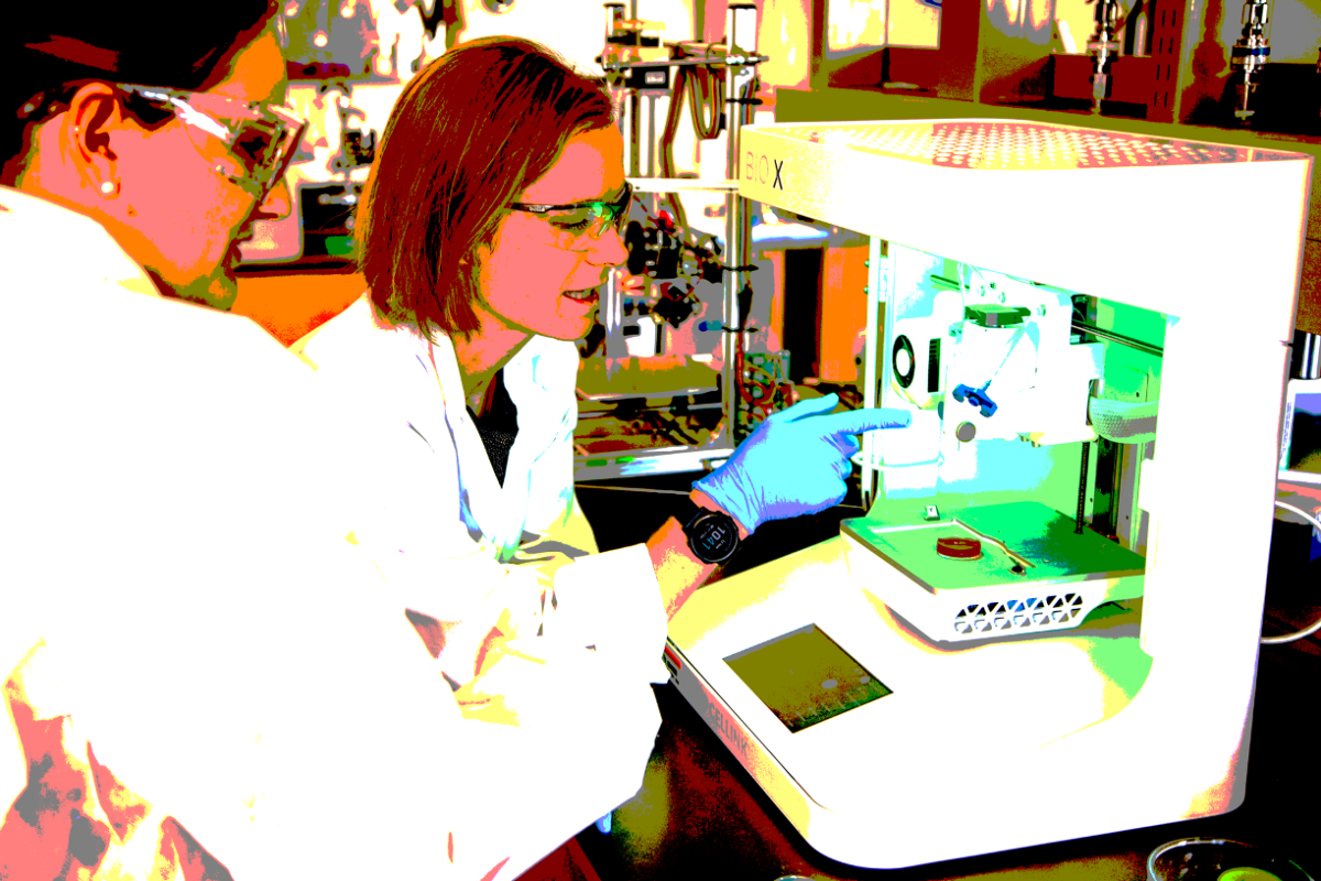 Scientists pointing at an instrument