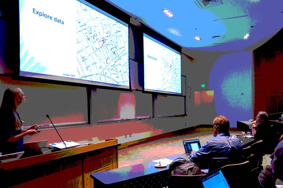 People looking at a screen with a presenter