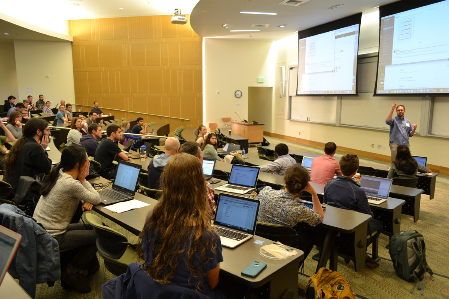 A group of students with computers in a lecture hall