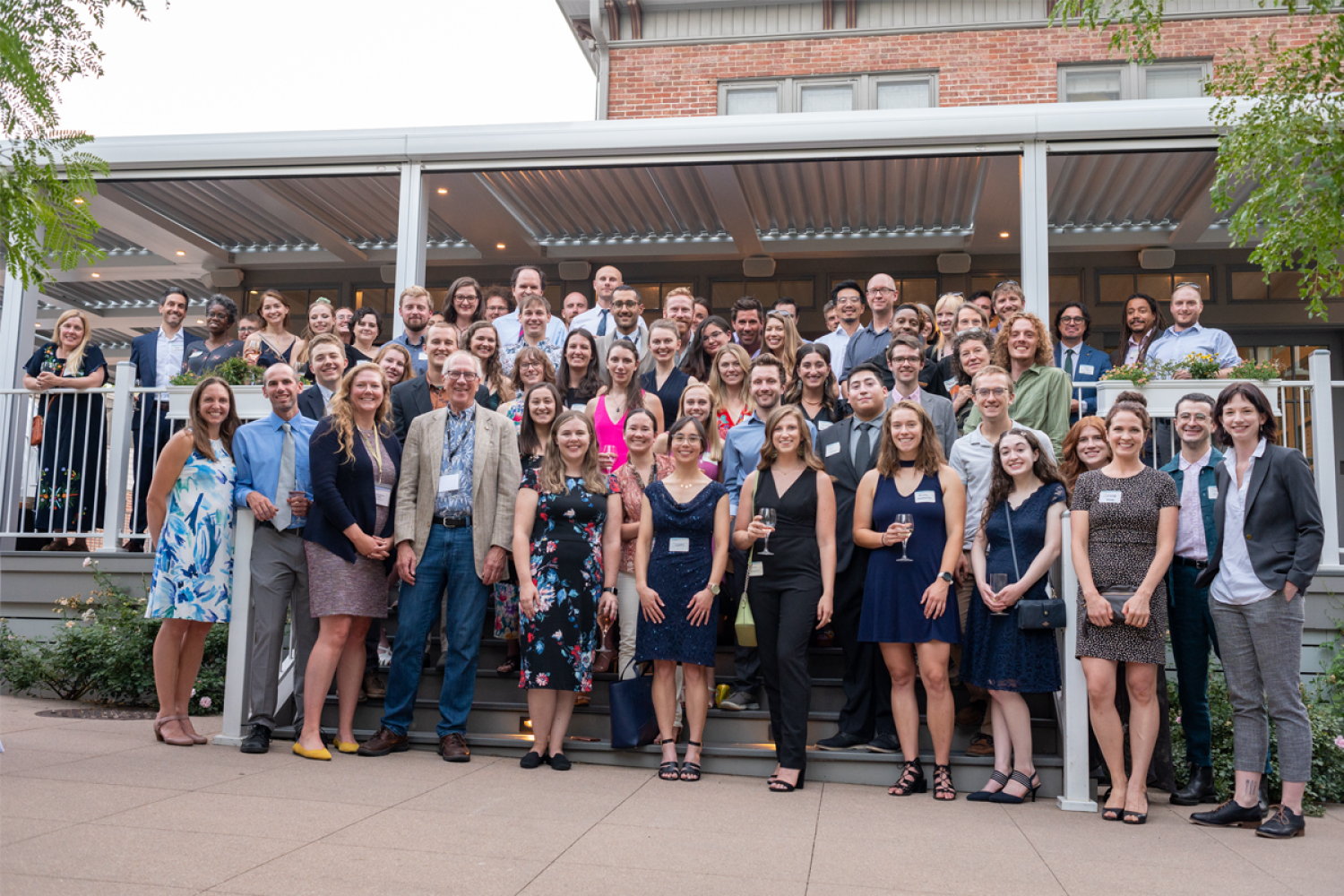 A group of people posing for a portrait: current and former IQ Bio students, faculty, and staff