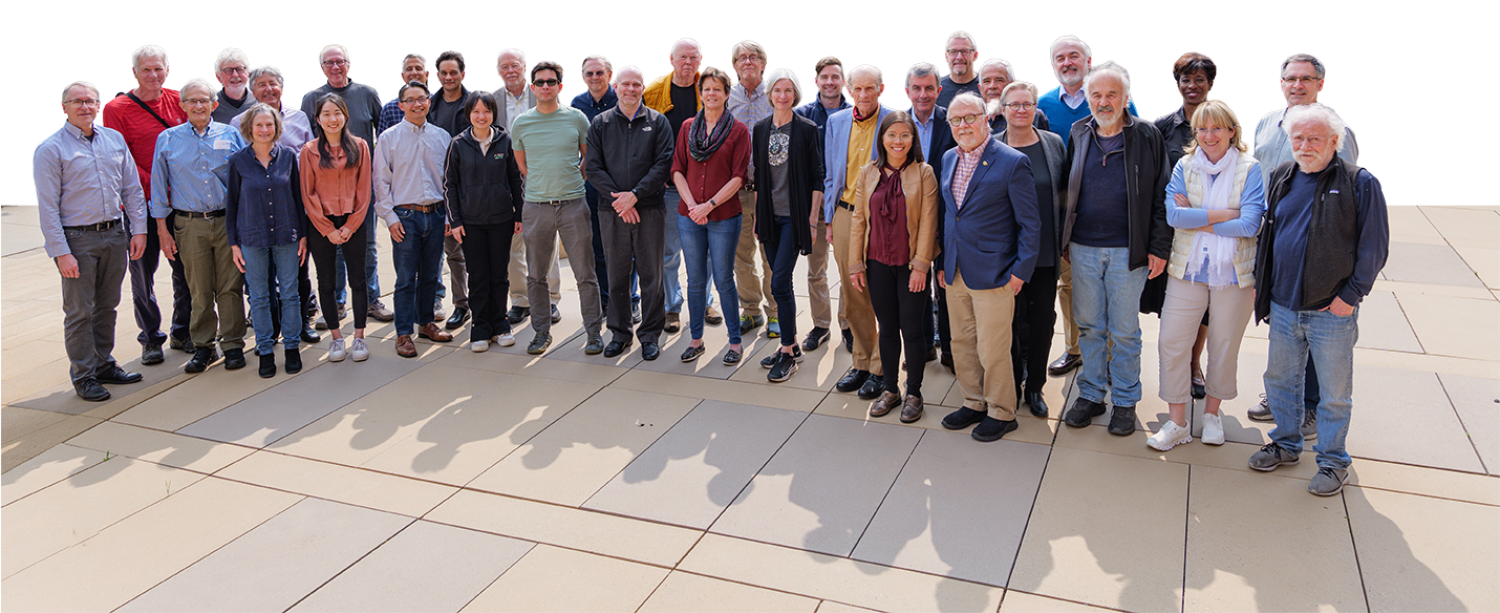 A group of RNA scientists standing in a semi-circle