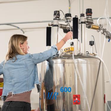 A researcher putting a sample into an NMR