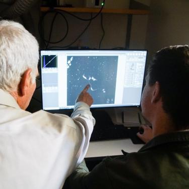 Parker lab members at a microscope