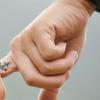 Two people bonded at their fingers
