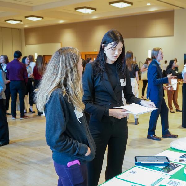 A female student chatting with a female company representative.