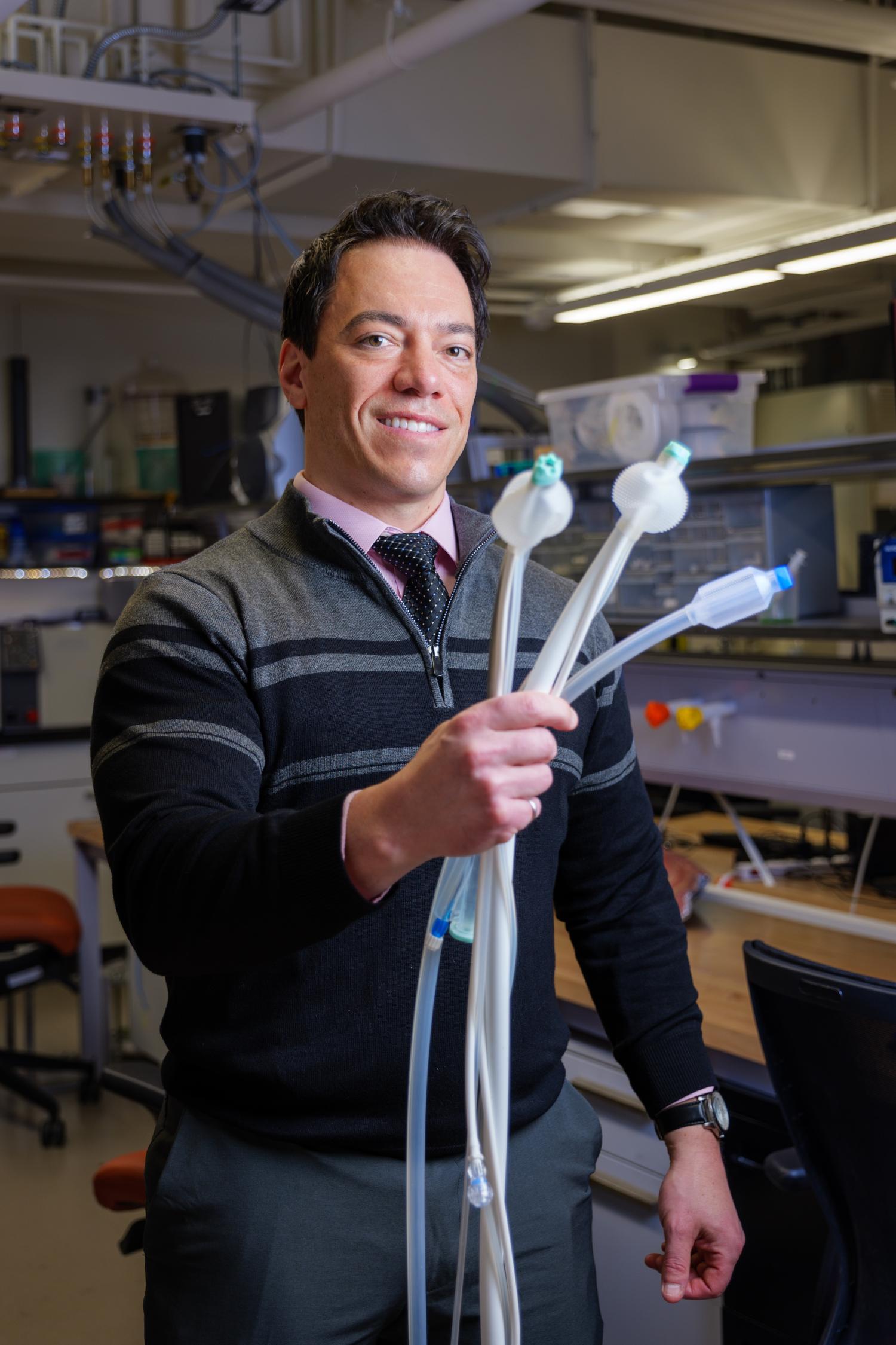 Mark Rentschler holding Aspero Medical devices
