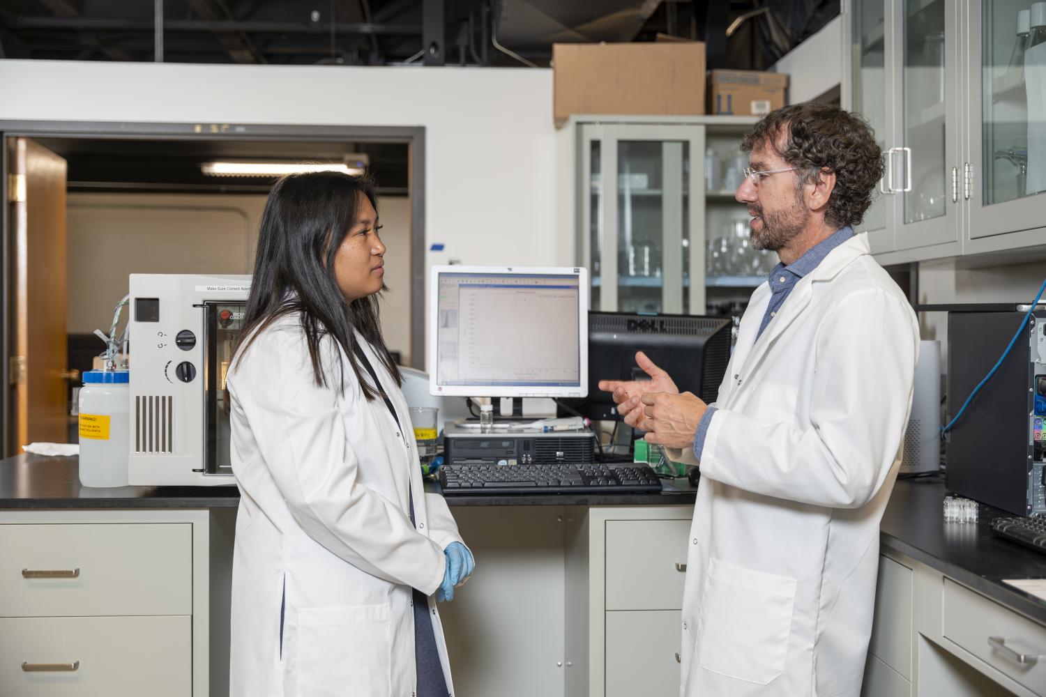 Professor Mark Borden talking to student in his lab