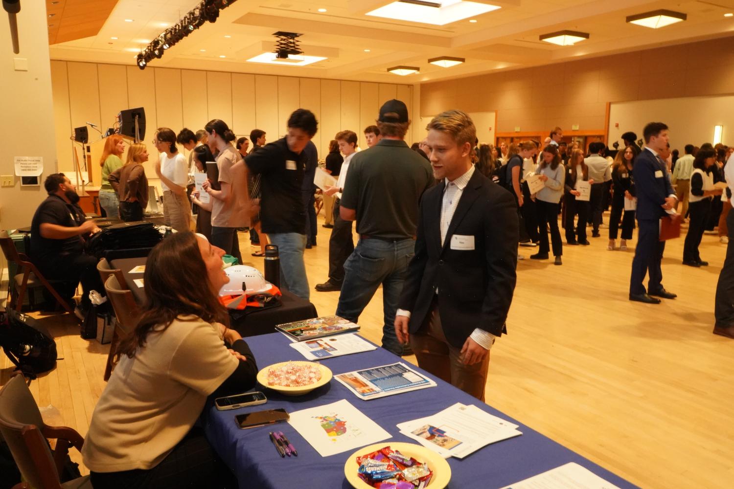 Male student talking to company representative at a career fair