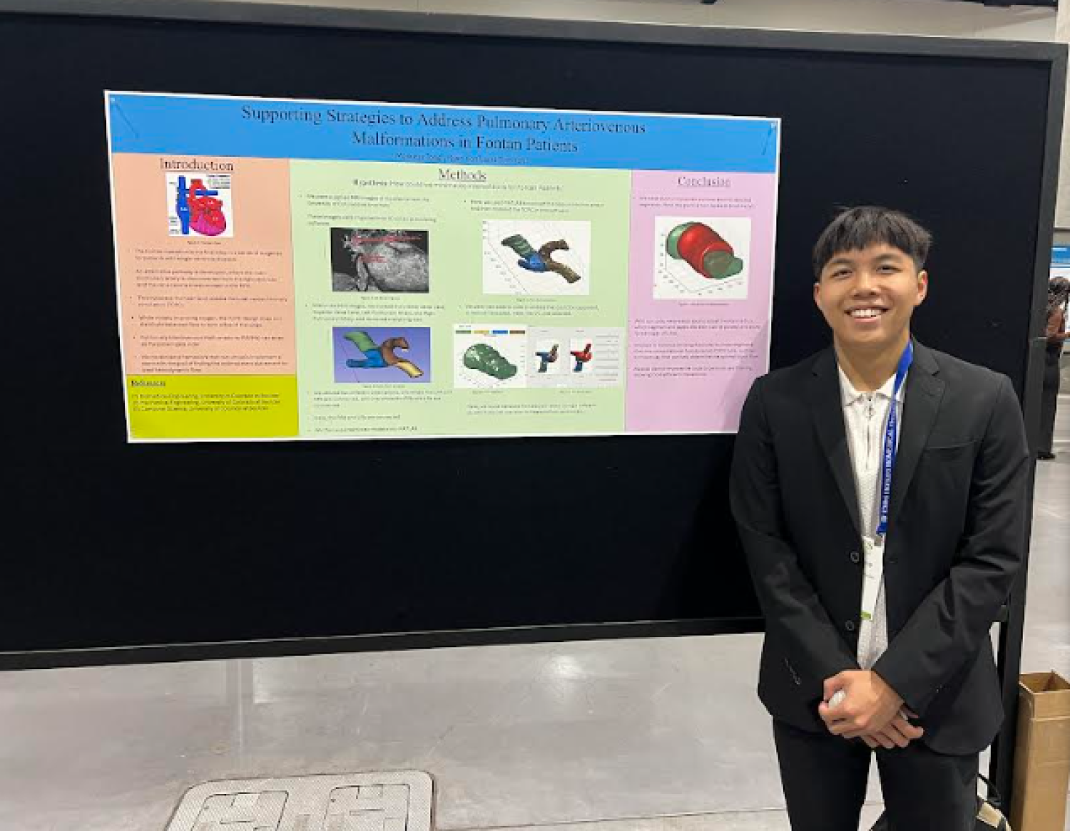 Markkus Tong standing next to his poster at the BMES annual meeting