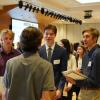 Three BME students smiling and talking with a recruiter.