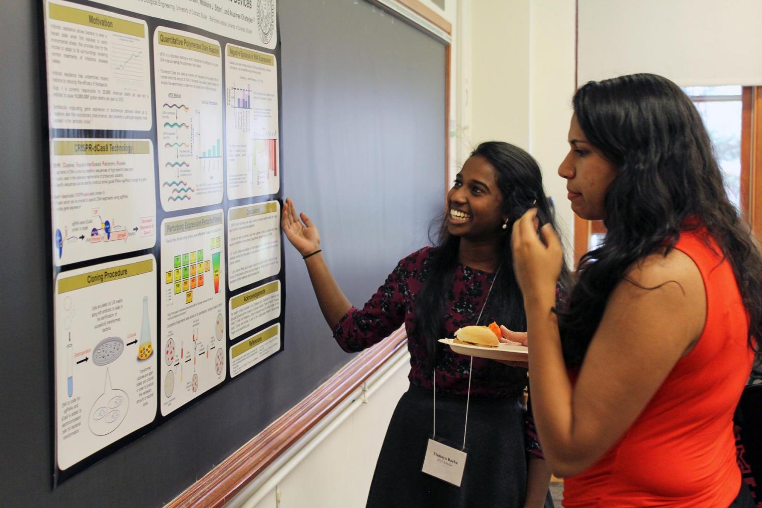 Two female students looking over a research project