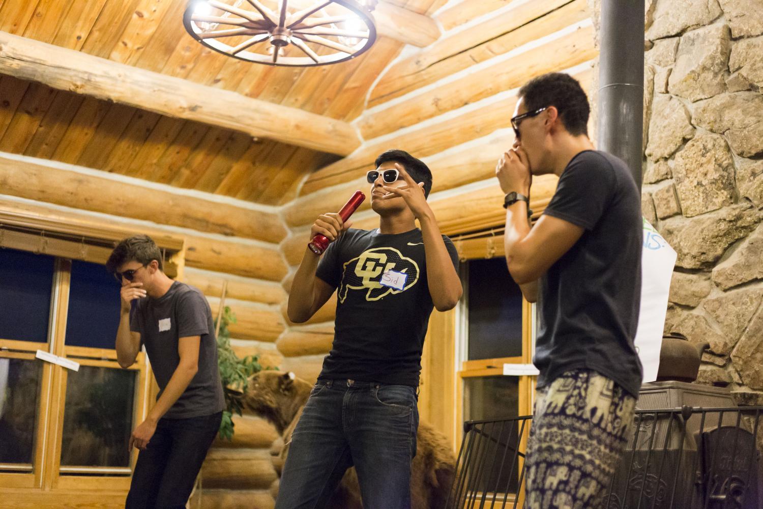 Three students performing a song.
