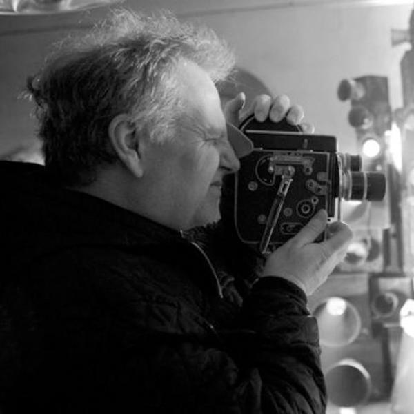Profile picture of Guy Maddin holding a Bolex Camera