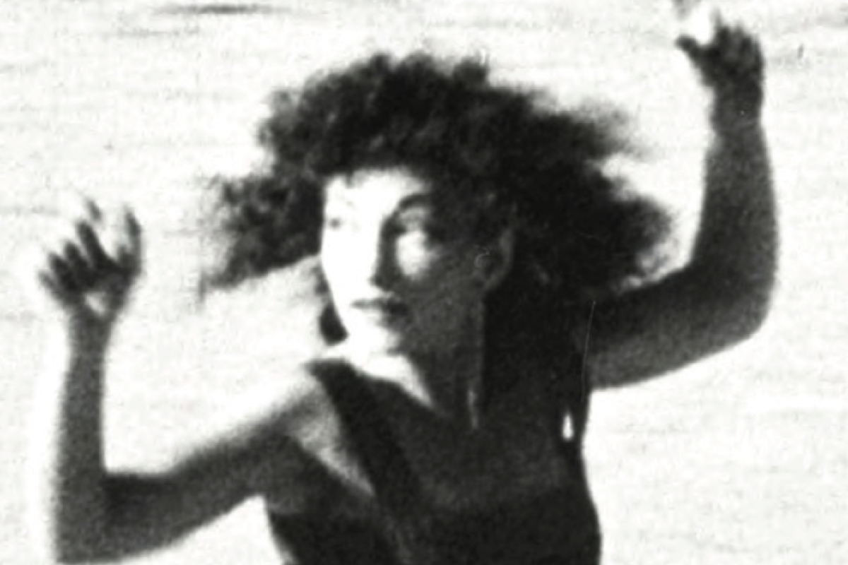 Maya Deren arms up running on beach