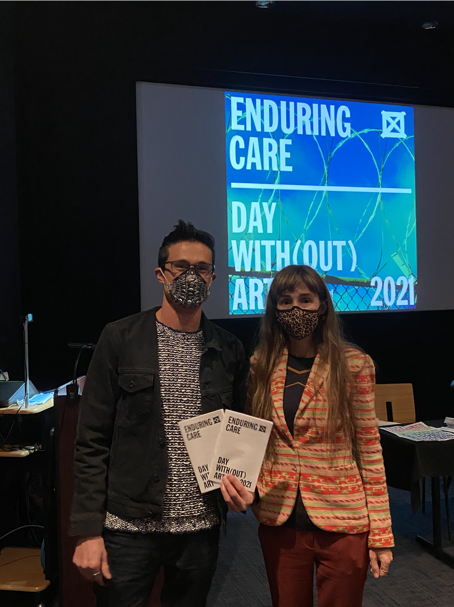Hanna and Emmanuel holding the phamplet for Day with(out) Art
