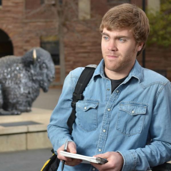 A student portrait with the Ralphie statue. Follow the rule of thirds to keep subjects off-center.