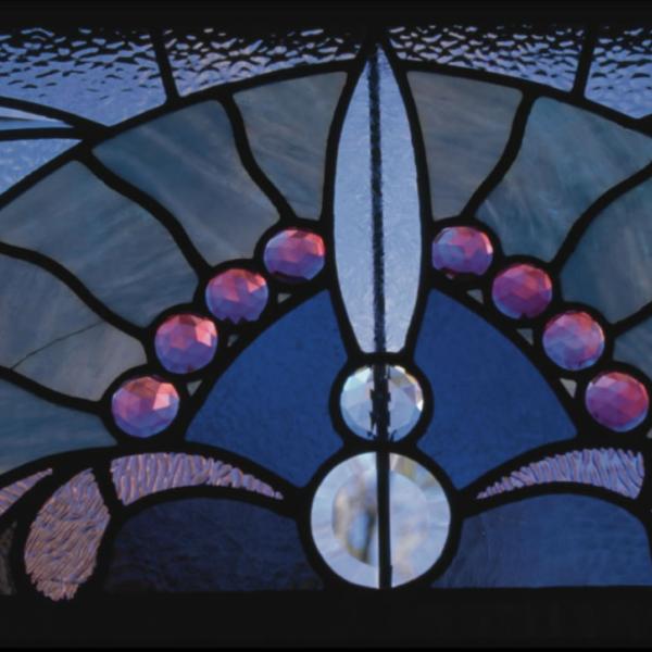 Close-up of stained-glass window in Macky Auditorium. Details and close-ups can help tell a broader story.