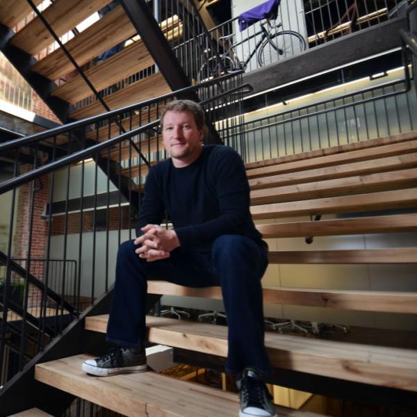 A portrait of CU Boulder alumnus Norm Shearer at his Denver offices. Use the environment as a compositional element in environmental portraits.
