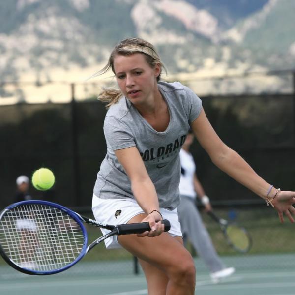 Student playing tennis