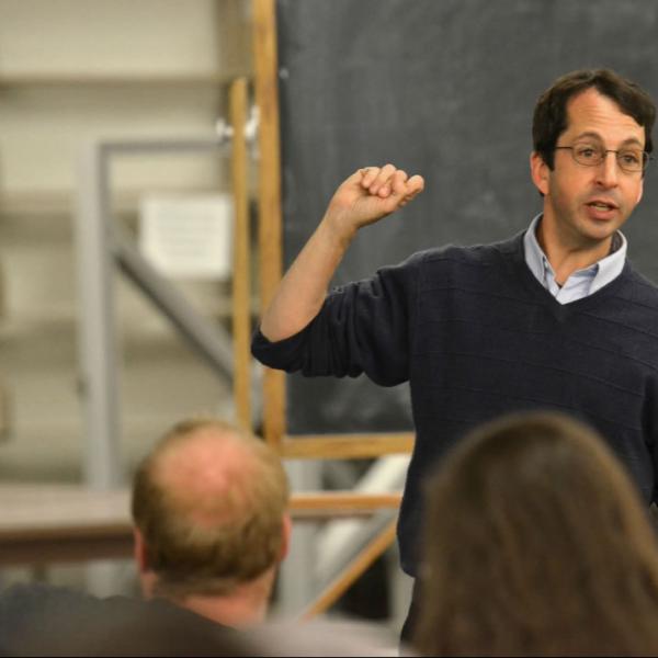 Physics professor Stephen Pollock teaches in class. Photograph simply and make the subject stand out.