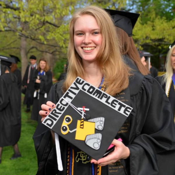 A graduate displays her decorated cap before the processional into Folsom Field. Don’t hesitate to ask subjects to pose when needed.