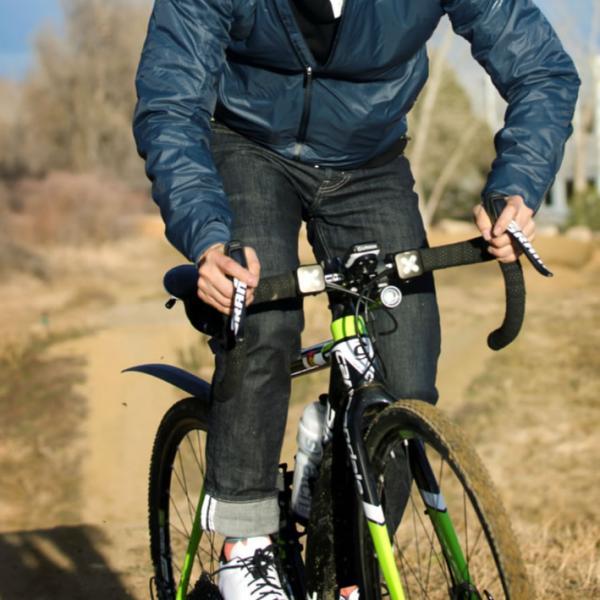 A faculty member rides his bike off campus. Use action for lifestyle photos.
