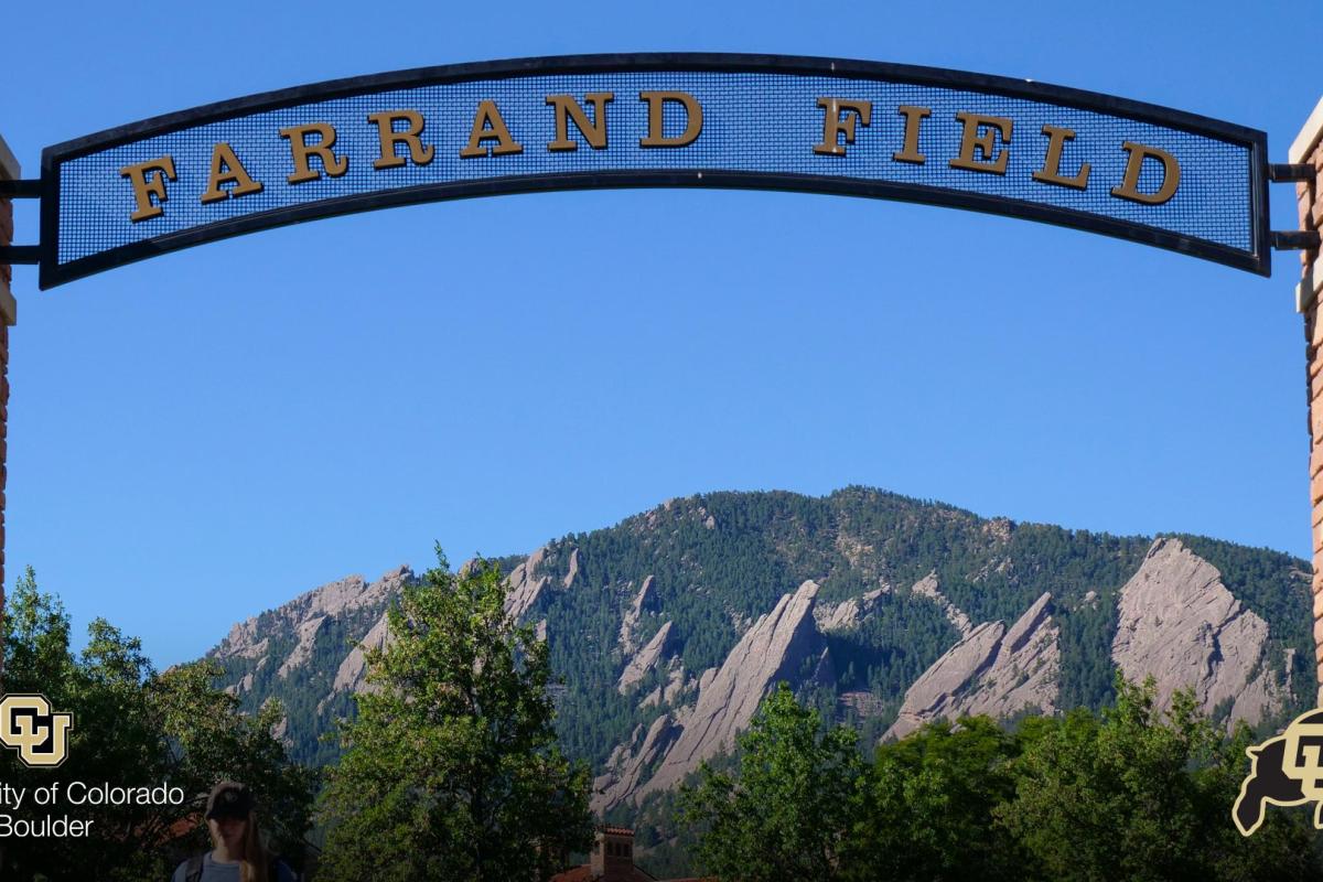 Sign over Farrand Field with Flatirons in the back