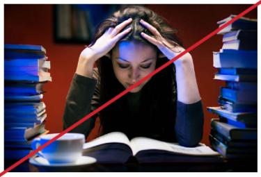 Student amid stacks of books under blue lights